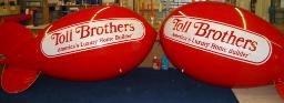 Red advertising blimp with the Toll Brothers logo